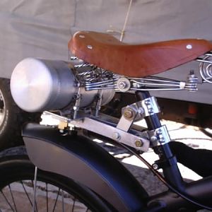 Hump back aluminum tank & classic leather 4 spring saddle, with an adjustable air shock in the seat post.