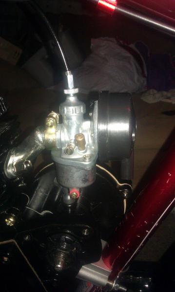 Carb put together with cable attached inside and mounted on motor.