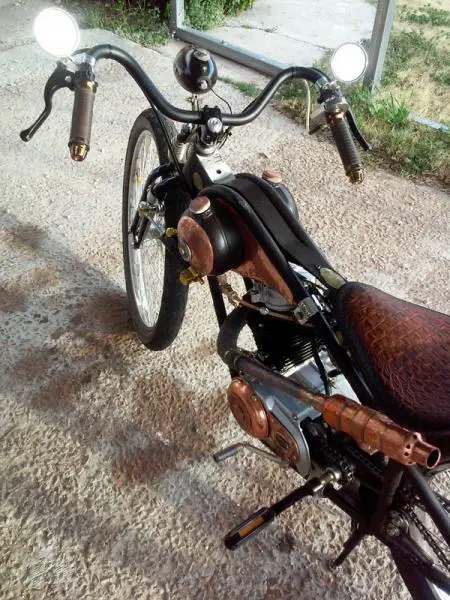 Pedals really work, kick start with 5 speed integrated transmission. Rams head bar shown in this photo with leather wrapped grips. Pure copper exhaust