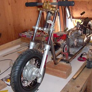 Motorized Scooter frame set-up, changed tires, custom handlebars to low, trying to find a solo chopper seat for cheap, gas tank from motorized bike wi