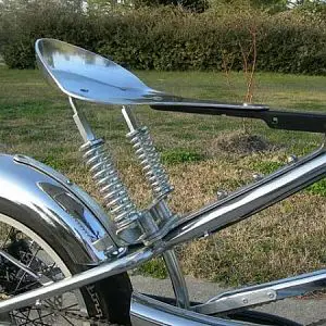 The funky springer seat was fabricated from a large aluminum frying pan from my father-in-laws restaurant. I used the frying pan's handle to mount the