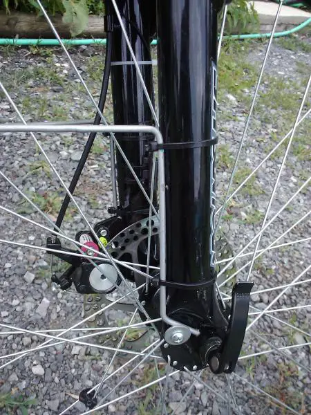 10 Guage round wire stock fender stays that are wire tied to the fork and held at the bottom with washers.