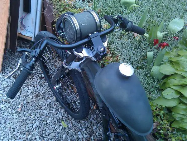 Clubman/ cafe racer handlebars and an "antiqued" gas tank. I dinged the tank up a bit with a hammer and hit with od green spraypaint and some flat bla