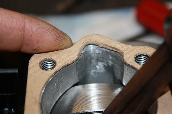folder 2 001
"Just a little off the top, Please.."
Trimming the bottom gasket to match, the Trans. Port.
Trans. Port was trimmed...
