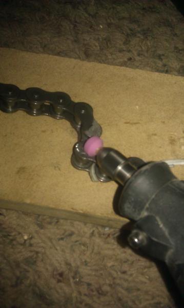 Grinding down pin on chain link to remove.