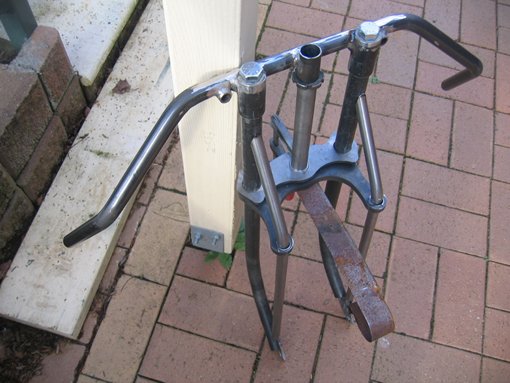 Handlebars in place ..these help to keep the forks in alignment...dummy spring in place for lenght before I get the spring made