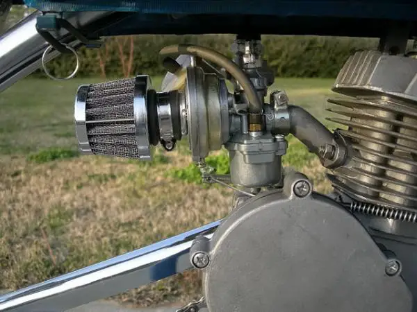 Here you can see the rubber retainer that holds the gas tank on. The low restriction air cleaner was purchased from Sick Bike Parts and modified to fi