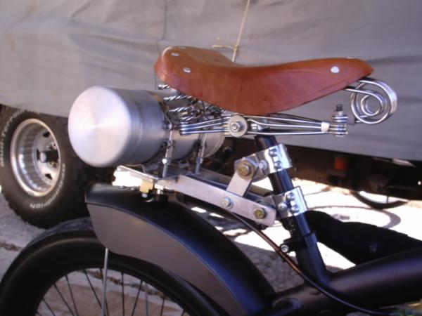 Hump back aluminum tank & classic leather 4 spring saddle, with an adjustable air shock in the seat post.