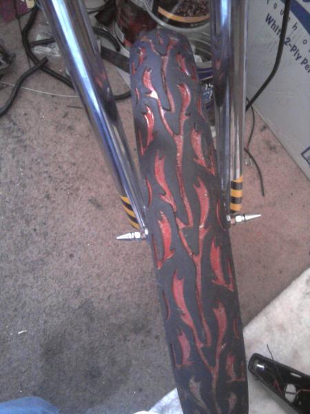 Painted flame tread tires, Axle spikes, 140 spoke wheels, disc brakes, yellow reflector tape