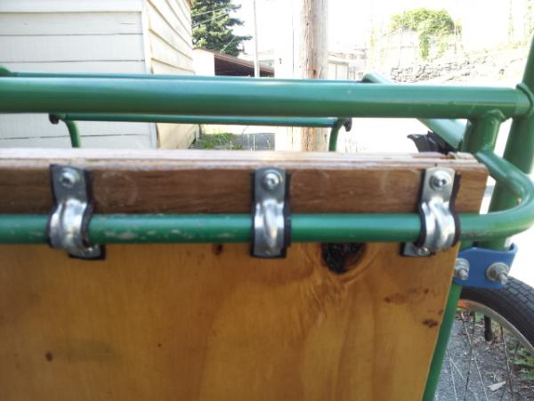 The front and back bars of the trailer are smaller in diameter, and set at a slightly different hieght to the middle bar.  There is a 1/4" plywood shi