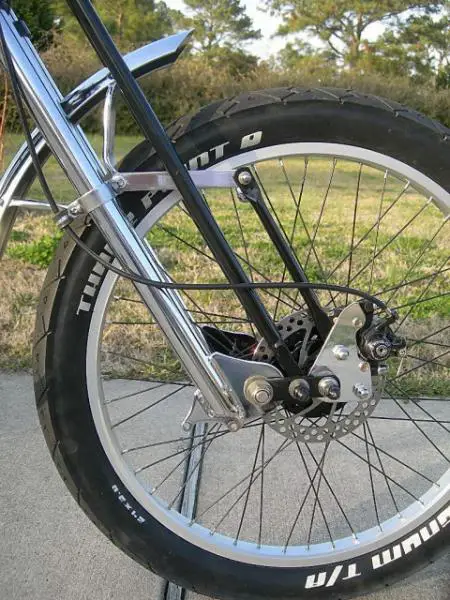 The front disc brake is mounted on a Harley-stye free floating plate that allows the brake to work in tandem with the springer.  The standard 160 disc
