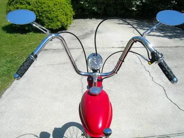 These wide bars provide a true vintage feel to the bike. The jocky shifter/suicide shifter is indexed with strong springs. It feels like a Hurst! I pu