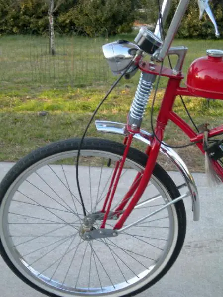 This photo shows the springer front end made from hardware stock and porch swing springs.  The pivot arms were made from scrap steel.  The speedo is a