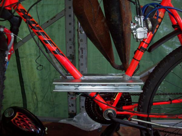 uni-strut mounts with pipe cut in half over frame to stop it from crushing the frame
